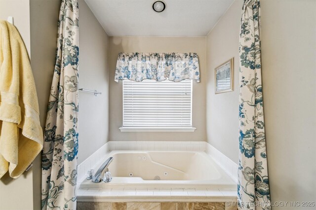 bathroom featuring tiled tub