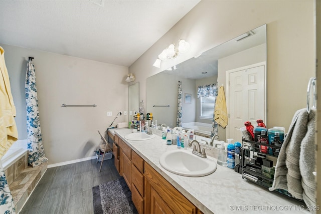 bathroom with a tub and vanity