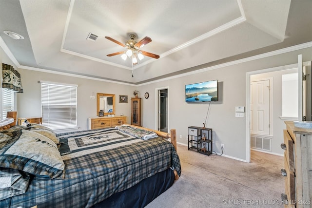 carpeted bedroom featuring ceiling fan, crown molding, and a raised ceiling