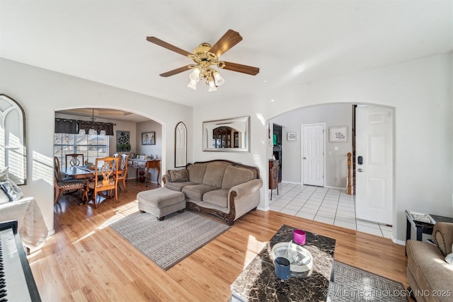 living room featuring ceiling fan and light hardwood / wood-style floors