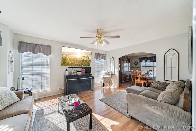 living room featuring ceiling fan and light hardwood / wood-style floors