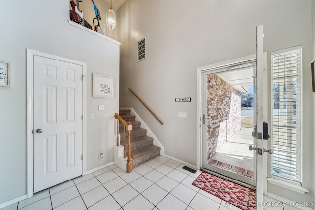 foyer entrance with light tile patterned flooring