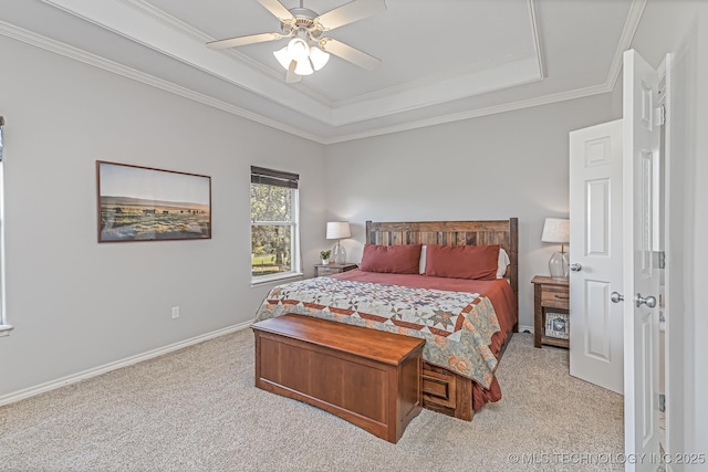 carpeted bedroom with a raised ceiling, ceiling fan, and crown molding