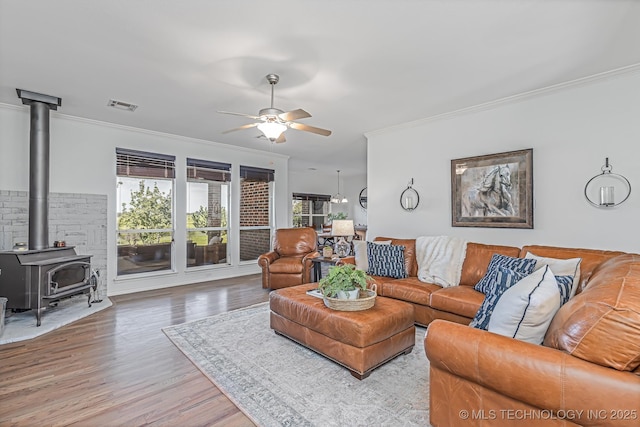 living room with ceiling fan, light wood-type flooring, a wealth of natural light, and ornamental molding