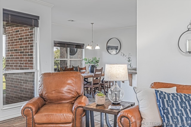 interior space featuring a notable chandelier, crown molding, and wood-type flooring