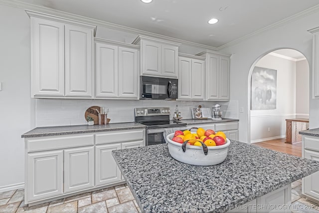 kitchen with a center island, electric range, crown molding, backsplash, and white cabinetry