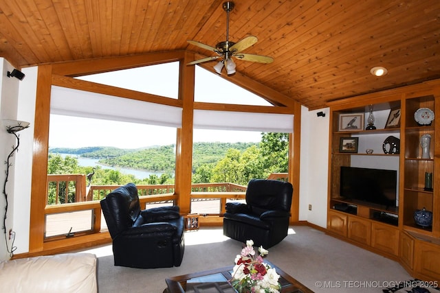 living room with lofted ceiling, a healthy amount of sunlight, a ceiling fan, and carpet floors