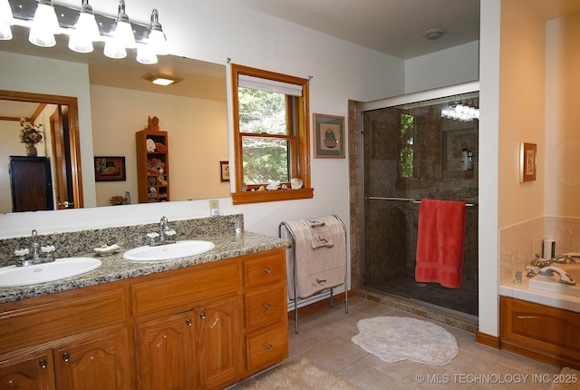 bathroom featuring tile patterned flooring, shower with separate bathtub, and vanity