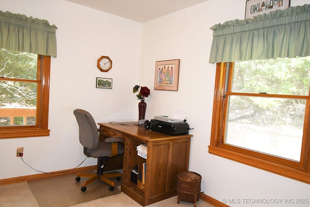 carpeted home office with a healthy amount of sunlight