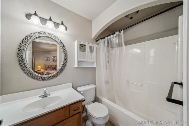 full bathroom with shower / tub combo with curtain, vanity, and toilet