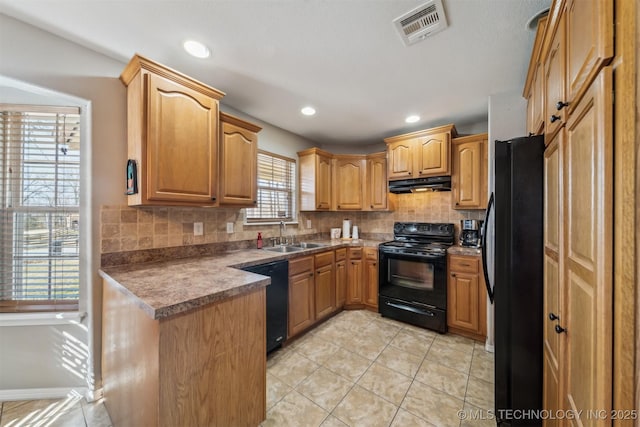 kitchen featuring light tile patterned flooring, black appliances, decorative backsplash, and sink