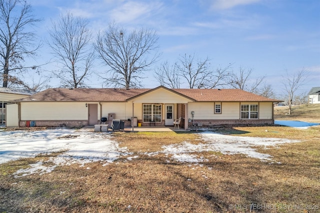 view of front of property featuring a lawn and a patio area