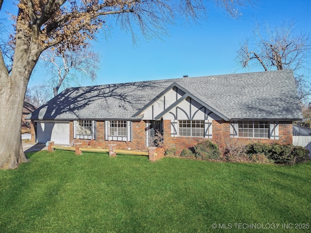 view of front of property featuring a front lawn and a garage