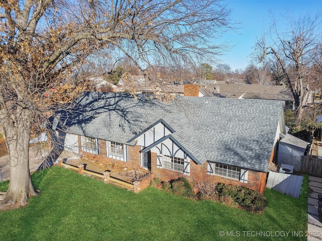 rear view of house with a yard