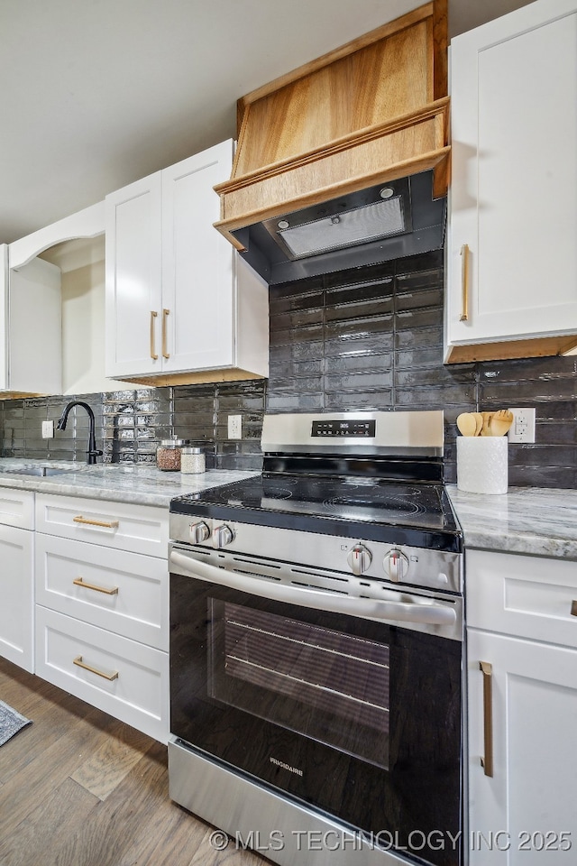 kitchen featuring custom exhaust hood, electric stove, dark hardwood / wood-style flooring, light stone counters, and white cabinets