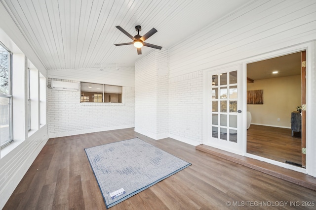 unfurnished sunroom featuring ceiling fan, a wall mounted AC, wooden ceiling, and vaulted ceiling