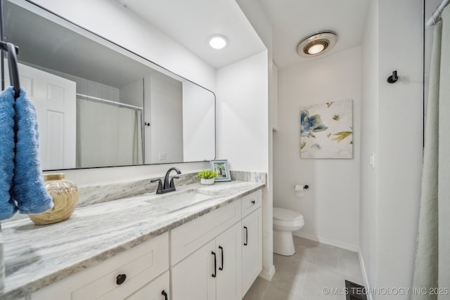 bathroom featuring toilet, a shower, vanity, and tile patterned flooring