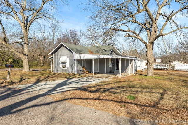 exterior space with a front yard and covered porch