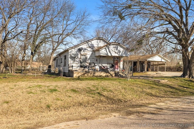 rear view of property with a lawn and covered porch