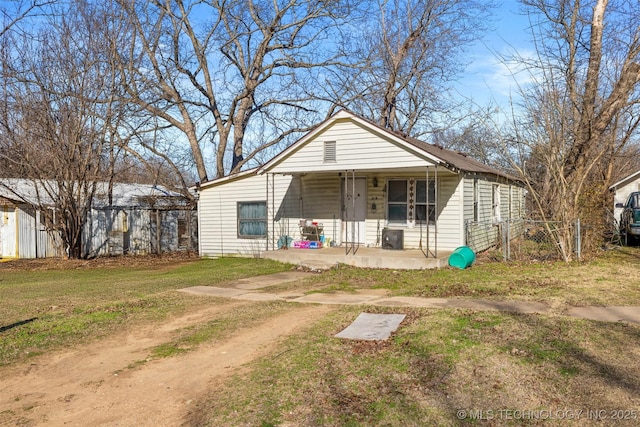 bungalow-style house featuring a front yard and covered porch