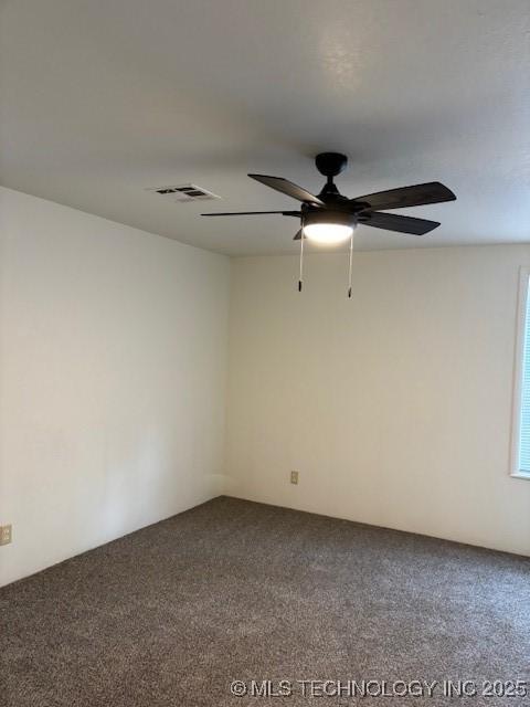 empty room with ceiling fan and carpet flooring