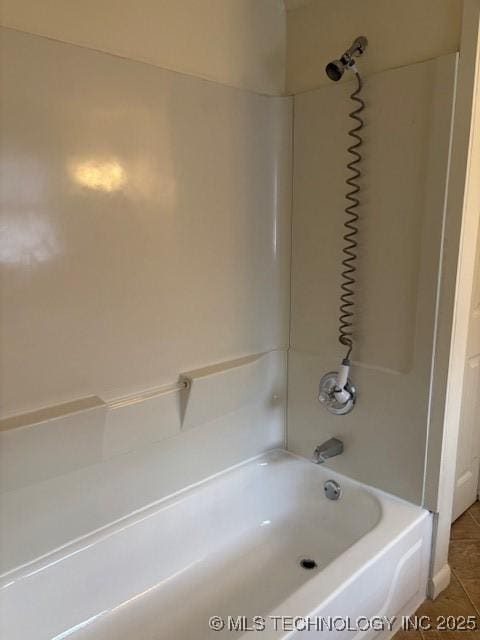 bathroom with tile patterned flooring and shower / bath combination