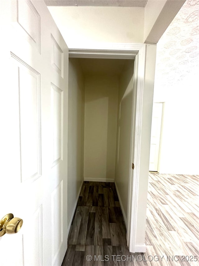 hallway with dark hardwood / wood-style floors