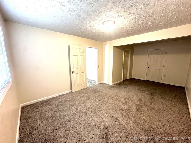 unfurnished bedroom featuring a textured ceiling and carpet flooring