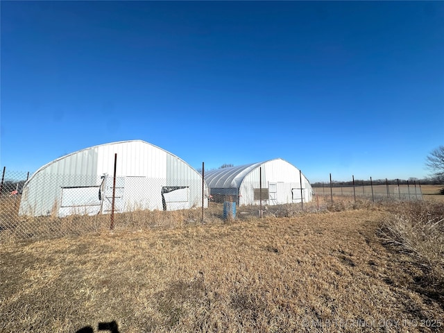 view of yard featuring a rural view and an outdoor structure