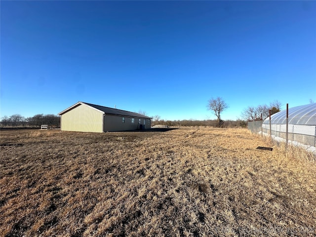 view of yard featuring an outbuilding and a rural view