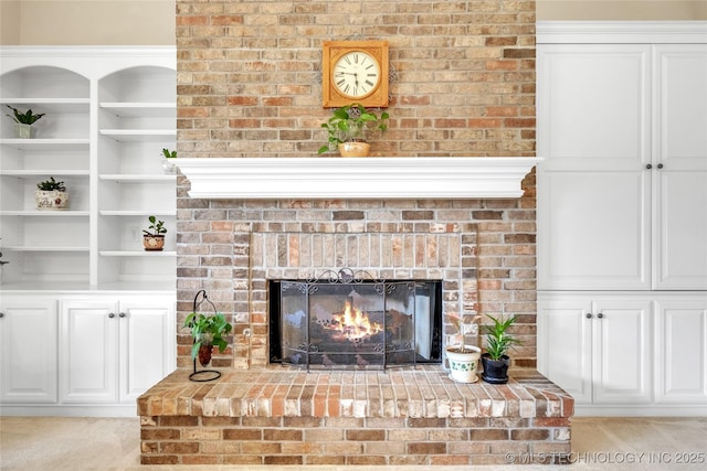 interior details with a brick fireplace and carpet flooring