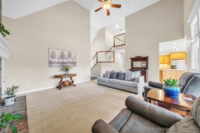 carpeted living room featuring ceiling fan and high vaulted ceiling