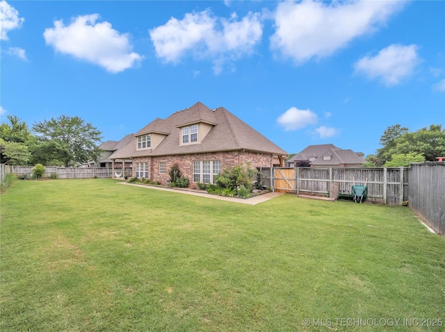 rear view of house with a lawn