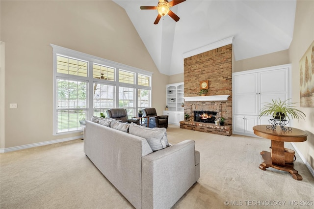 carpeted living room featuring a towering ceiling, a brick fireplace, and ceiling fan