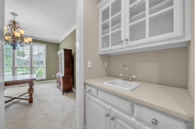 bar featuring white cabinets, crown molding, light carpet, and sink