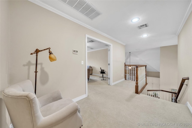 sitting room with ornamental molding and light colored carpet