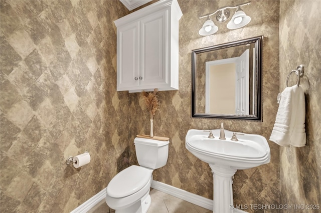 bathroom featuring toilet and tile patterned floors