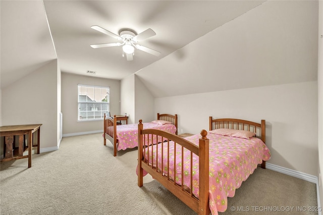 carpeted bedroom with ceiling fan and vaulted ceiling