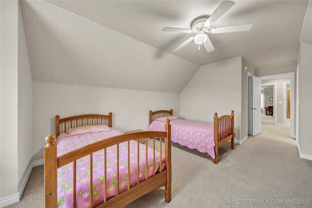 bedroom featuring ceiling fan, vaulted ceiling, and light colored carpet