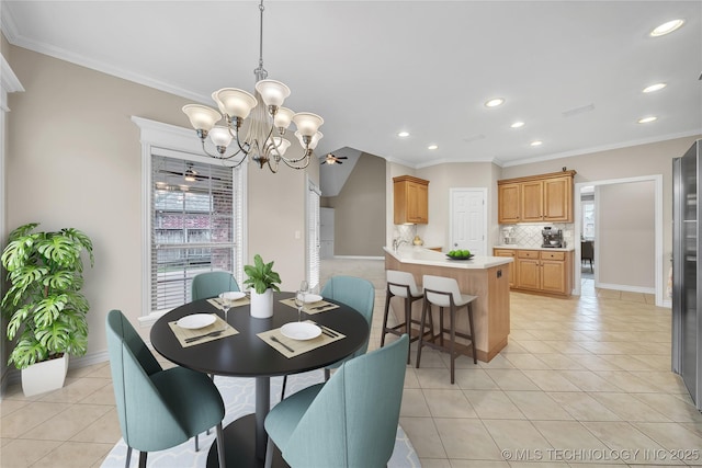 tiled dining space with ornamental molding and ceiling fan with notable chandelier