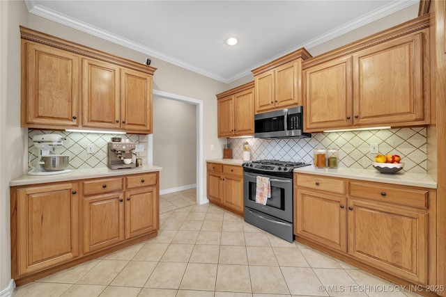 kitchen featuring stainless steel appliances, tasteful backsplash, light tile patterned floors, and crown molding