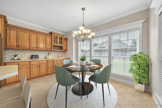 dining room featuring an inviting chandelier, light tile patterned floors, and crown molding