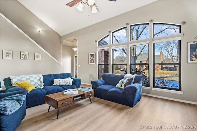 living room featuring vaulted ceiling, ceiling fan, and hardwood / wood-style floors