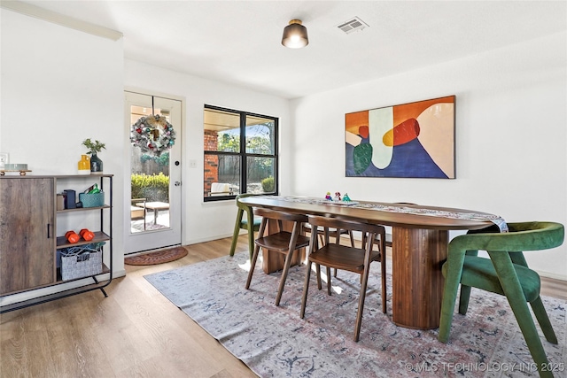 dining space with light wood-type flooring