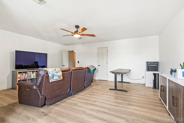 living room with light wood-type flooring and ceiling fan