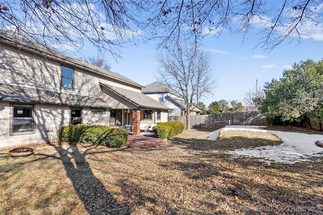 back of house with a lawn