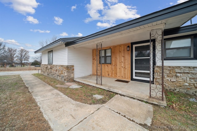 view of exterior entry with covered porch