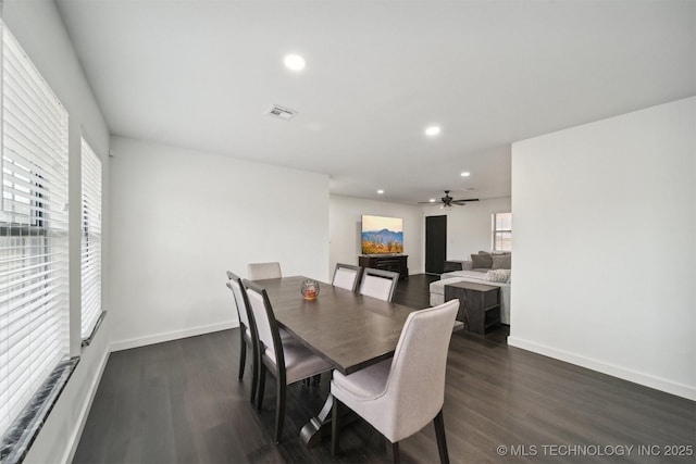 dining area featuring ceiling fan and dark hardwood / wood-style floors