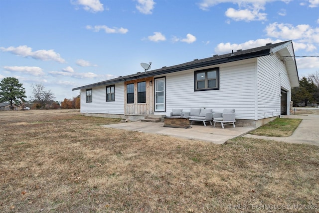 back of house featuring a lawn, a garage, and a patio