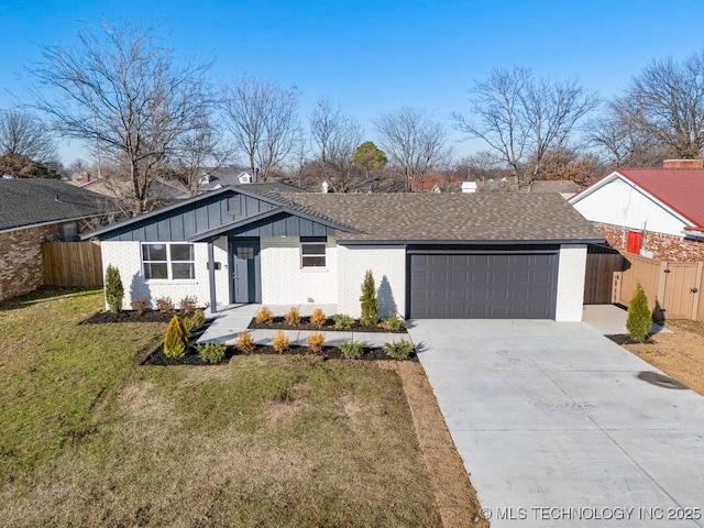 view of front of home featuring a front lawn and a garage